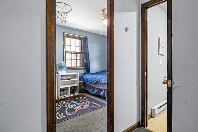 carpeted bedroom featuring a baseboard radiator