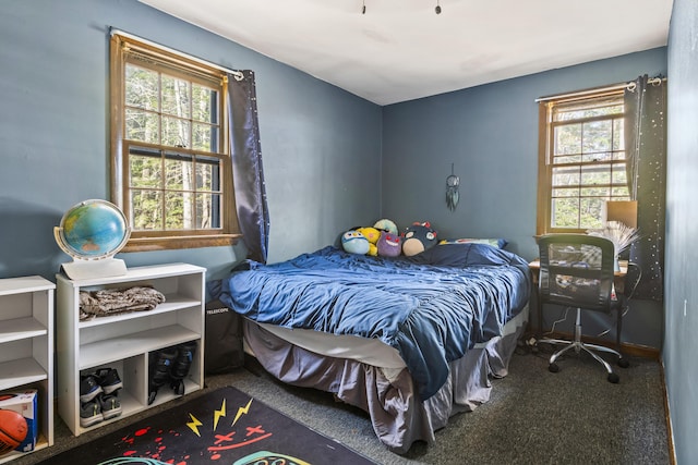 carpeted bedroom featuring multiple windows