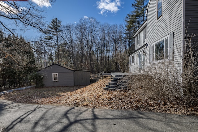 view of home's exterior with an outbuilding