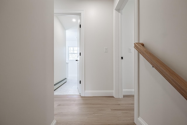 hall featuring light wood-type flooring and a baseboard radiator