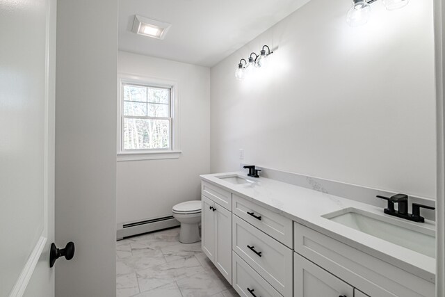 bathroom with toilet, vanity, and a baseboard heating unit