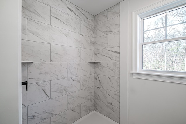 bathroom with a tile shower