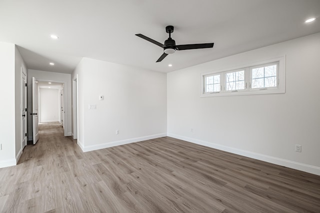 spare room featuring light wood-type flooring and ceiling fan