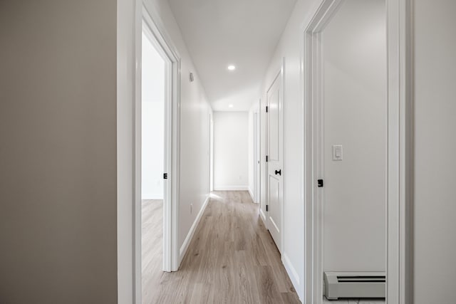 hall featuring light hardwood / wood-style flooring and a baseboard heating unit