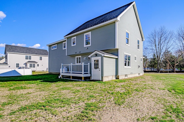 rear view of property with a lawn and a deck