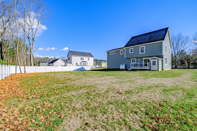 rear view of property featuring a yard