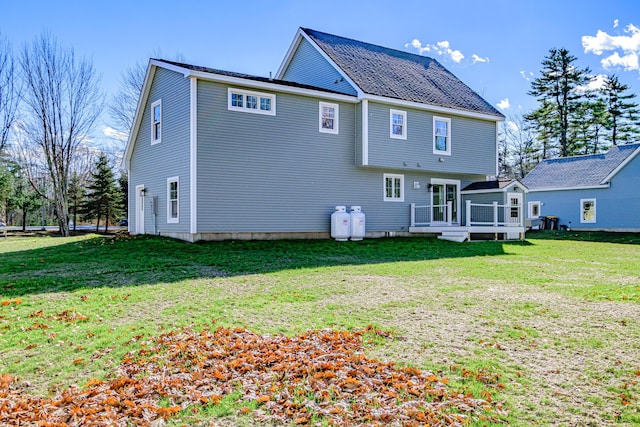 back of house featuring a yard and a wooden deck