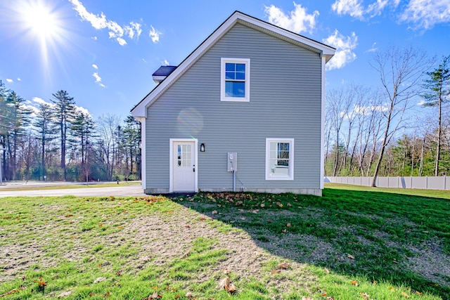 rear view of property with a lawn