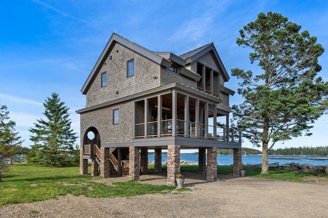 back of property featuring a water view