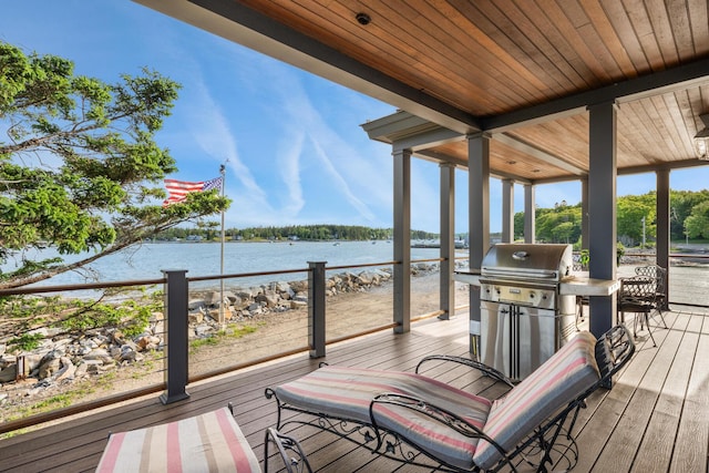 deck featuring a grill and a water view