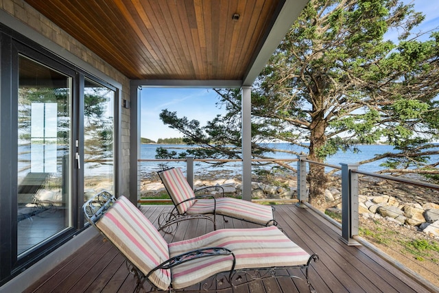 wooden terrace featuring a water view