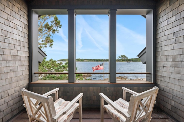 sunroom with a healthy amount of sunlight and a water view