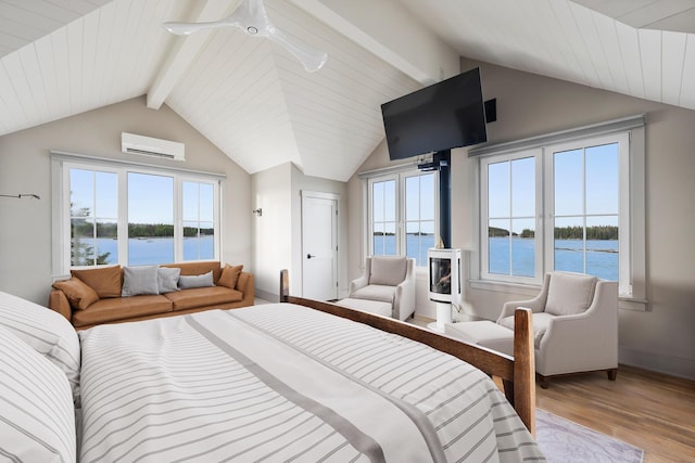 bedroom with a wall mounted AC, lofted ceiling with beams, and light hardwood / wood-style flooring