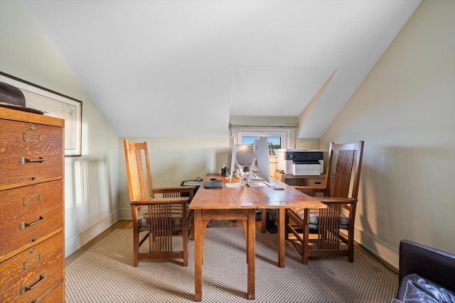 dining area with lofted ceiling and carpet floors