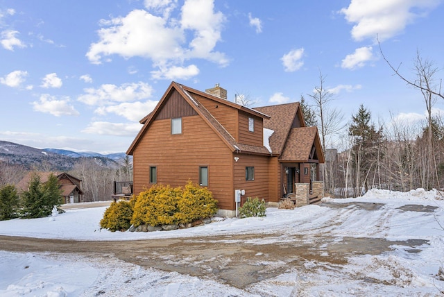 view of snowy exterior featuring a mountain view