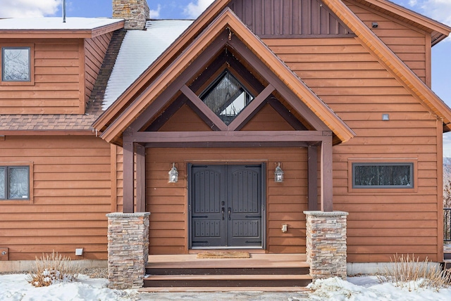 view of snow covered property entrance