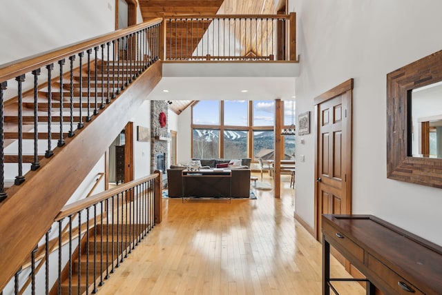 interior space with hardwood / wood-style flooring, a fireplace, and a high ceiling