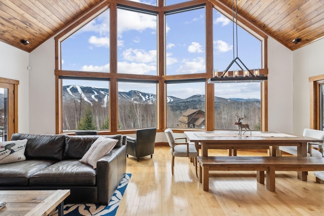 sunroom / solarium with a mountain view, wooden ceiling, and vaulted ceiling