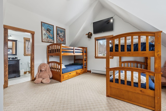 bedroom with light colored carpet, lofted ceiling, and connected bathroom