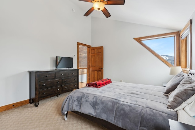 bedroom with ceiling fan, light colored carpet, and vaulted ceiling