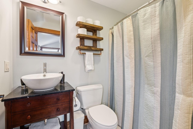 bathroom featuring toilet and vanity