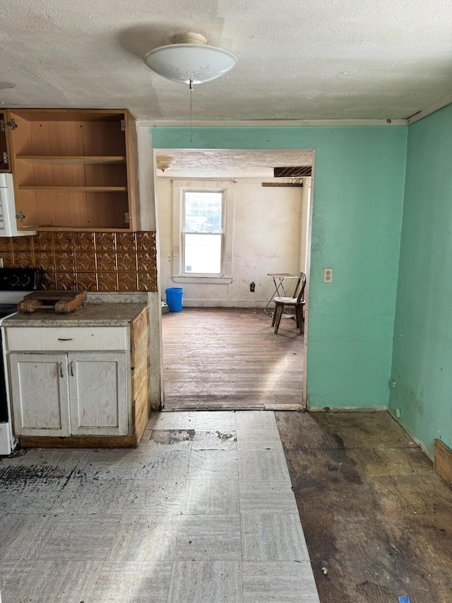 kitchen featuring a textured ceiling and stove