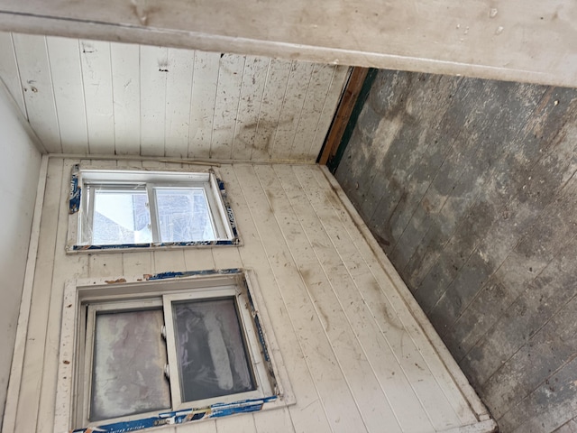 interior space with wood ceiling, wood walls, and beamed ceiling