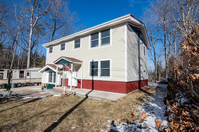 view of front of property with a lawn and a patio