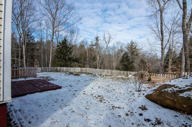 yard layered in snow with a wooden deck