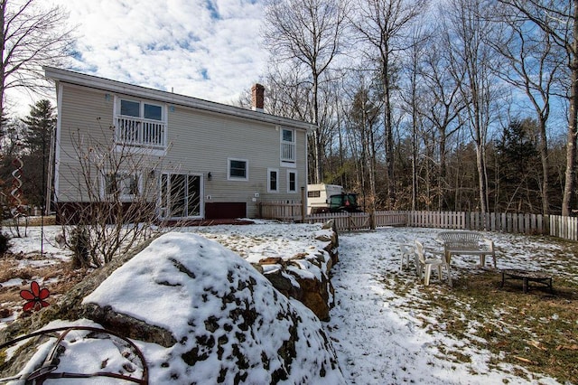 view of snow covered rear of property