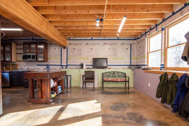 interior space featuring concrete floors and beam ceiling