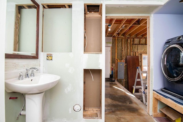 bathroom with sink, washer / dryer, and electric panel