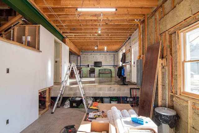 miscellaneous room with concrete floors and electric panel