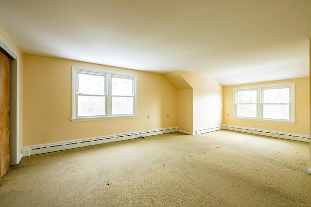 bonus room featuring vaulted ceiling, baseboard heating, and plenty of natural light