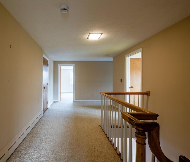 hall with baseboard heating and a textured ceiling