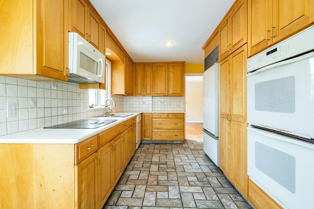 kitchen featuring white appliances, sink, and decorative backsplash