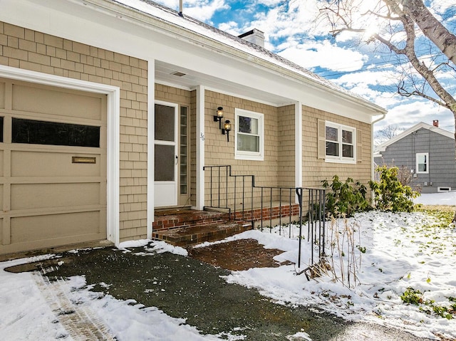 view of snow covered property entrance