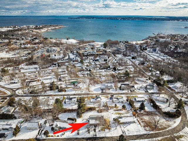 snowy aerial view with a water view