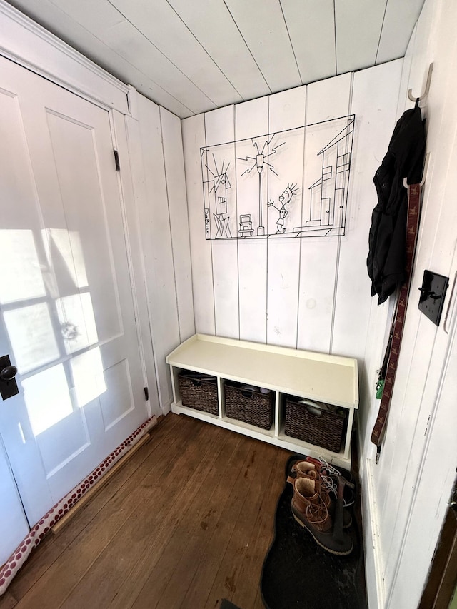 mudroom featuring wood walls and dark wood-type flooring