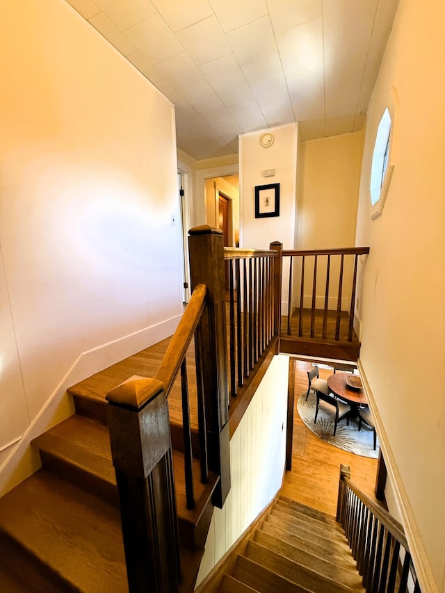 stairway with hardwood / wood-style flooring