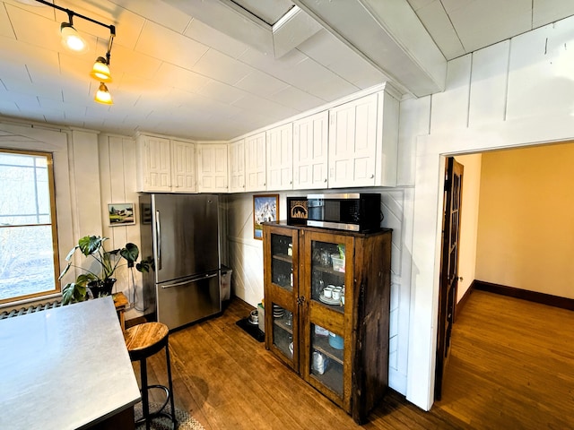 kitchen featuring stainless steel appliances, white cabinets, and dark wood-type flooring