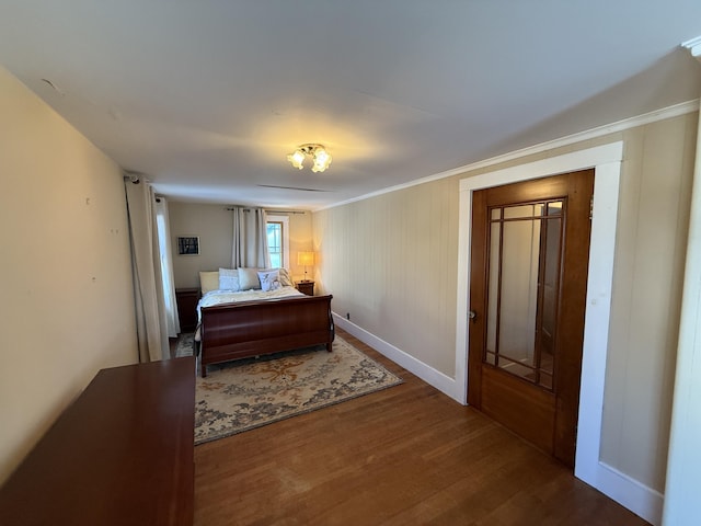 bedroom featuring hardwood / wood-style floors and crown molding