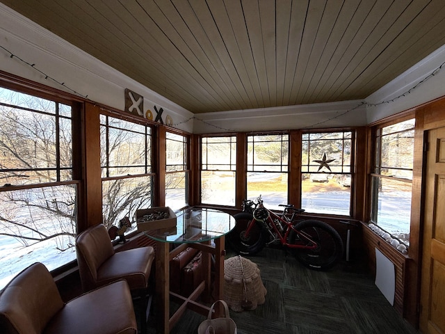 sunroom featuring wooden ceiling and plenty of natural light