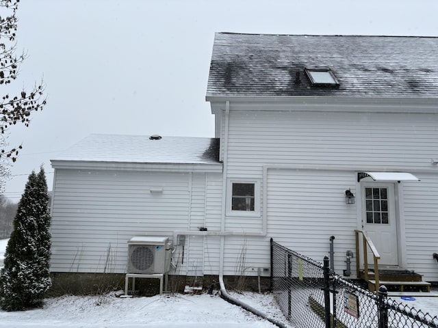 snow covered property featuring ac unit