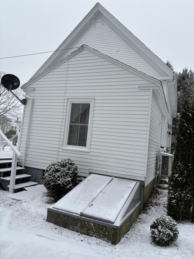 view of snow covered exterior with central air condition unit