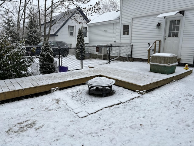 snow covered deck with an outdoor fire pit