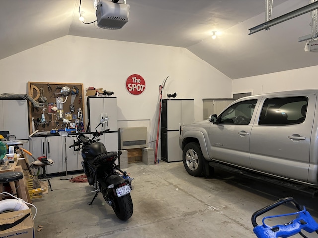 garage featuring a garage door opener and a workshop area