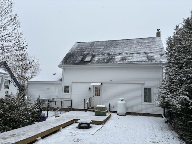 snow covered property with a fire pit