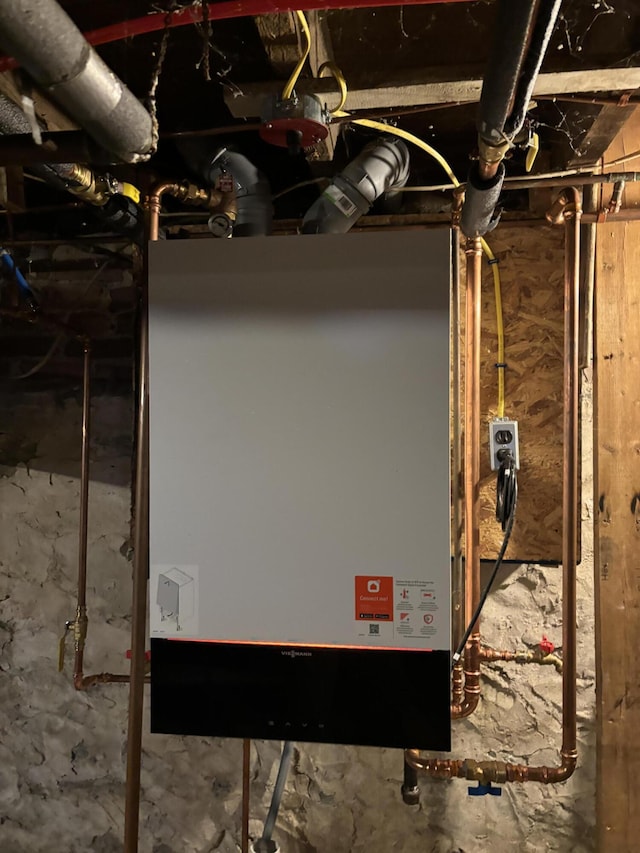 utility room featuring water heater