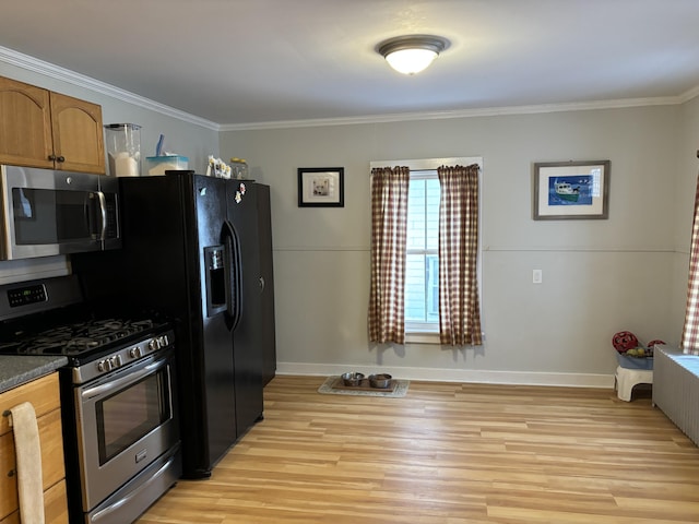 kitchen featuring ornamental molding, stainless steel appliances, and light hardwood / wood-style flooring